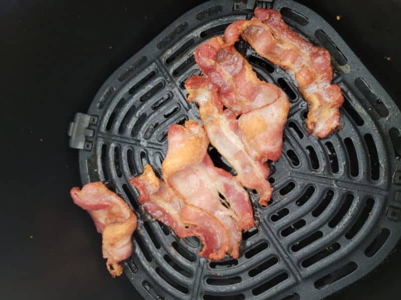 Air fried bacon in an air fryer basket