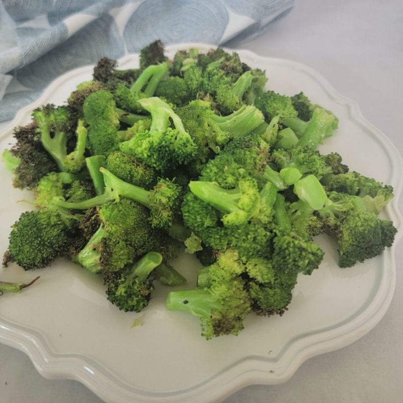 air fried broccoli on a white plate