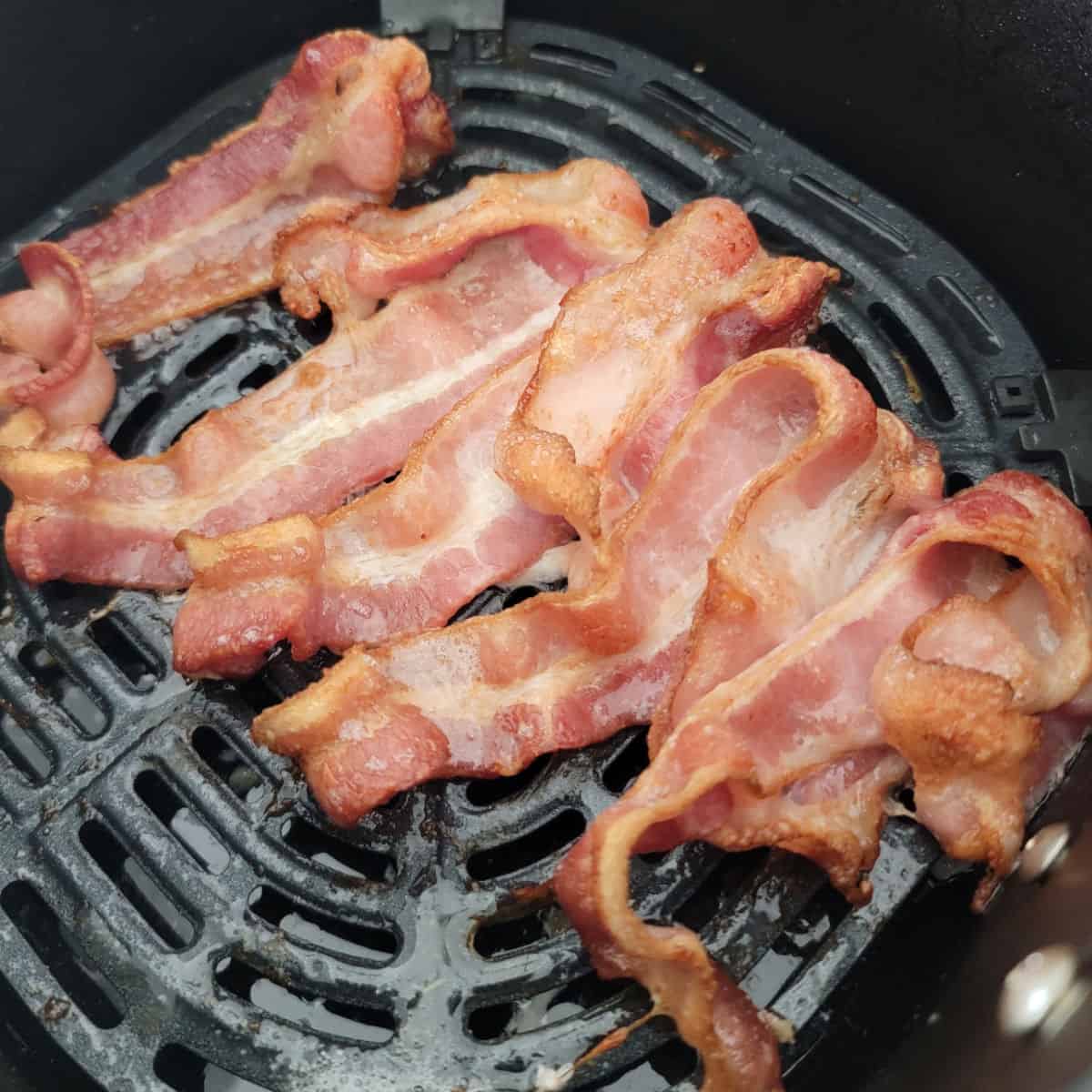 air fried bacon in an air fryer basket