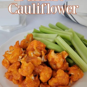 Air Fryer Buffalo Cauliflower text over a plate with buffalo cauliflower and celery sticks