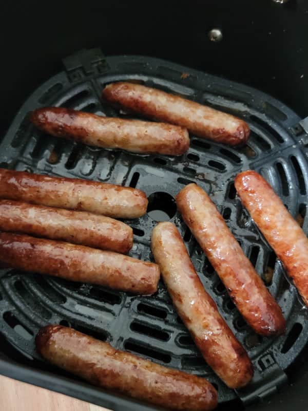 cooked air fryer sausage links in the air fryer basket