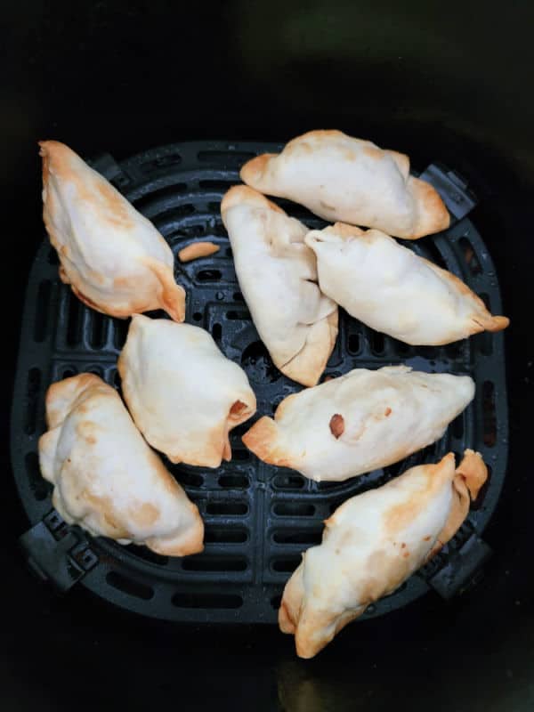 Air fried dumplings in an air fryer basket