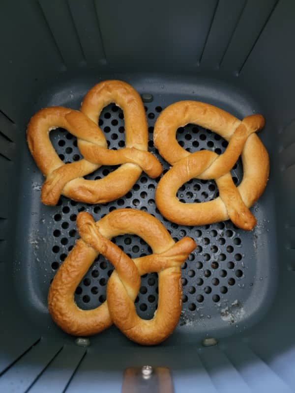 Cooked frozen pretzels in an air fryer basket