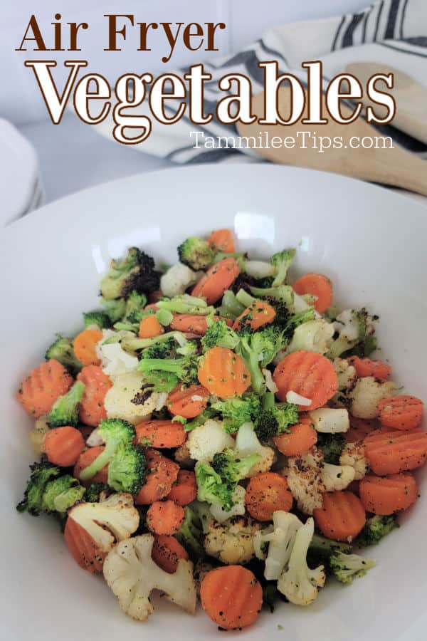 Air Fryer Vegetables text over a white bowl with carrots, broccoli, and cauliflower