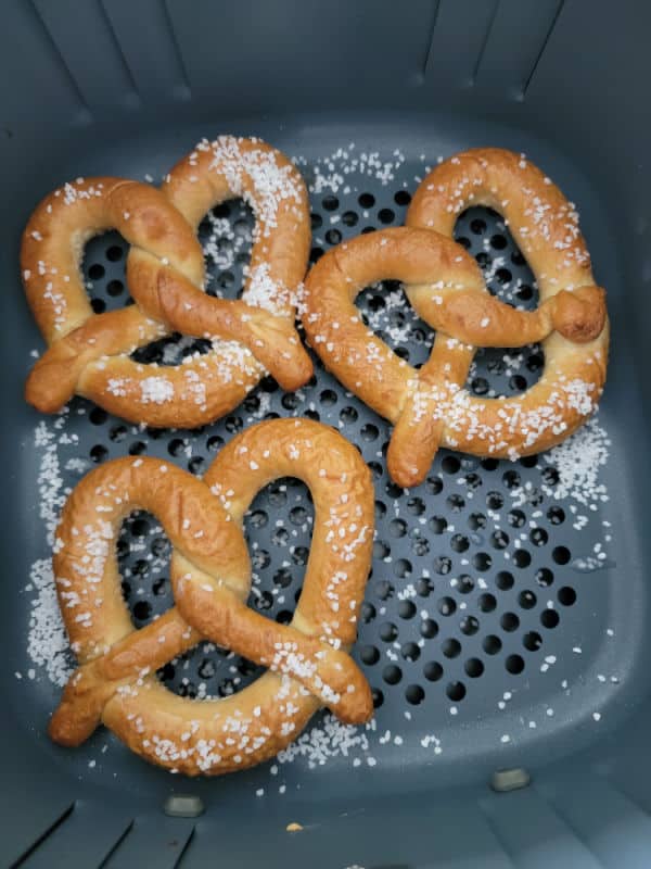 Frozen pretzels in an air fryer basket