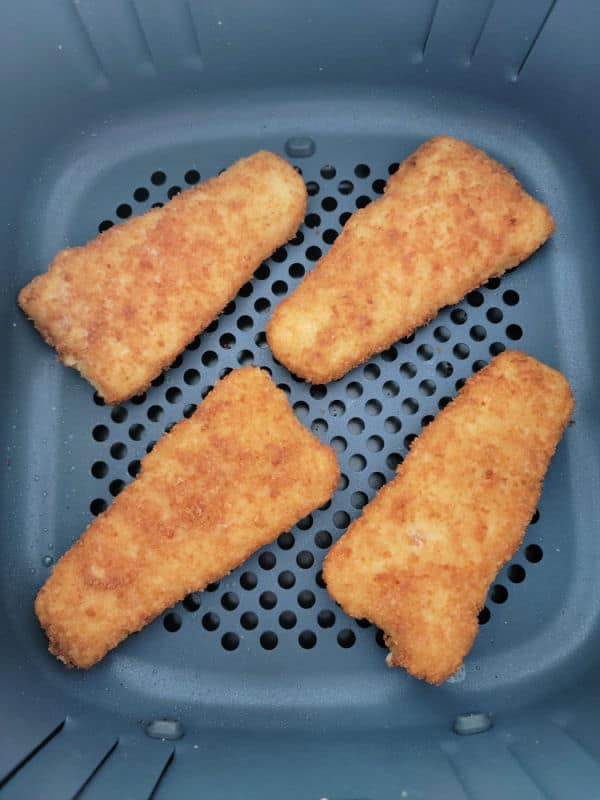 frozen fish fillets in an air fryer basket