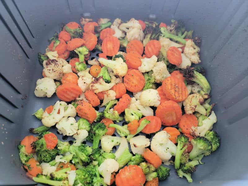 mixed vegetables cooked in an air fryer basket