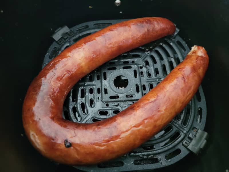 Air fried kielbasa in an air fryer basket