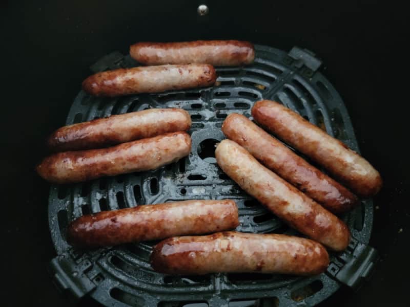 air fried sausage links in an air fryer basket