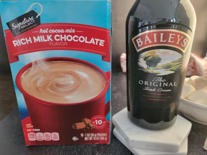 Baileys Hot Chocolate ingredients, hot cocoa mix and a bottle of Baileys Original Irish Cream