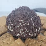 Chocolate Chip Cheese Ball on a white plate with graham crackers