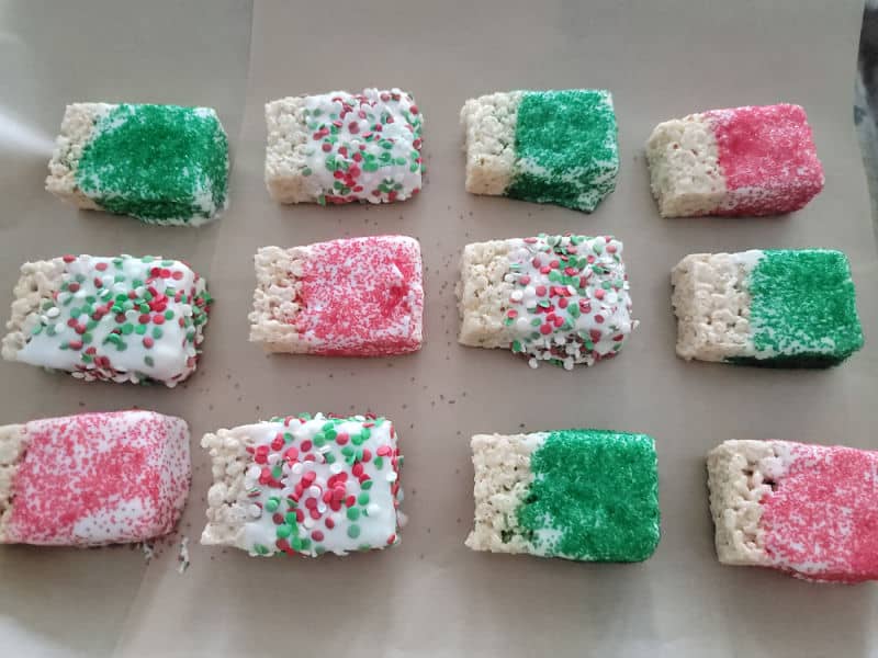 Chocolate covered rice krispie treats covered in holiday sprinkles 