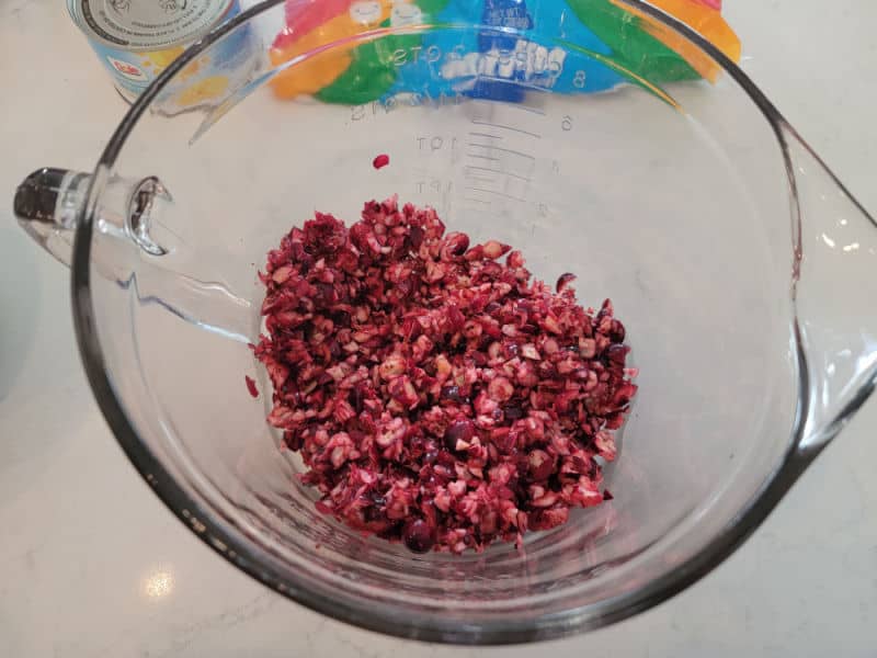 shredded cranberries in a glass bowl for cranberry fluff salad