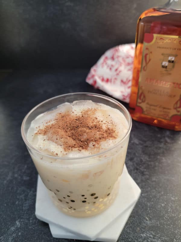 Amaretto Eggnog cocktail garnished with ground nutmeg in glass