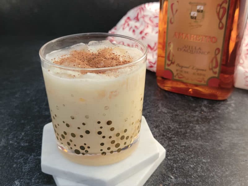 Easy Amaretto Eggnog Cocktail garnished with ground nutmeg in a glass