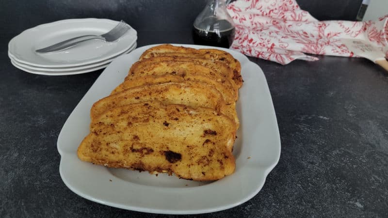 Slices of Eggnog French Toast on a white platter