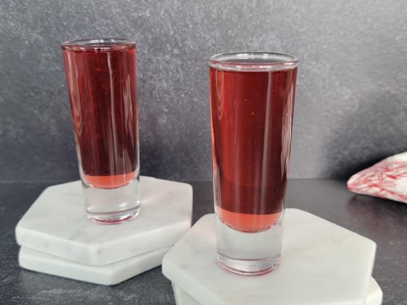 Red Snapper Shots on white marble coasters