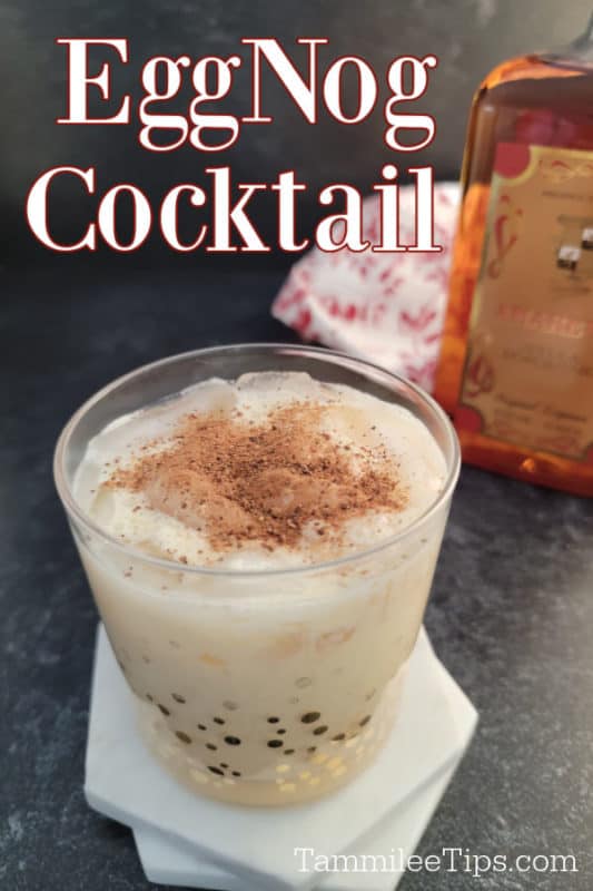 Eggnog cocktail text written over a Amaretto Eggnog cocktail garnished with ground nutmeg in glass