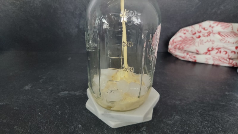 Eggnog pour into a mason jar for an eggnog mudslide cocktail