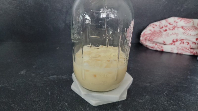 Vodka and eggnog in a mason jar for an eggnog mudslide cocktail