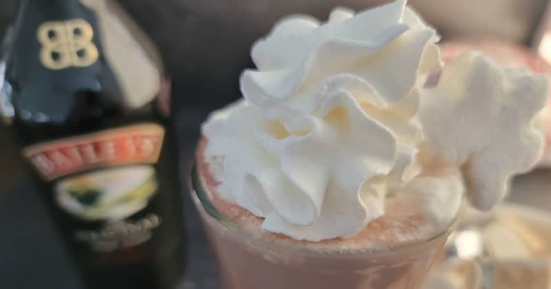 Baileys Hot Chocolate with whipped cream in a glass mug