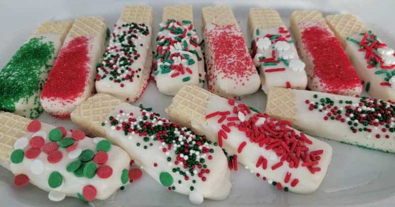 White chocolate dipped wafer cookies coated in holiday sprinkles