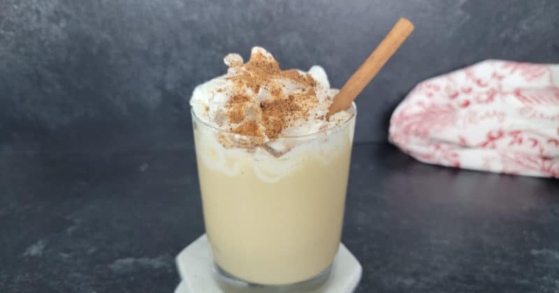 Eggnog Mudslide Cocktail topped with whipped cream, ground nutmeg, with a cinnamon stick