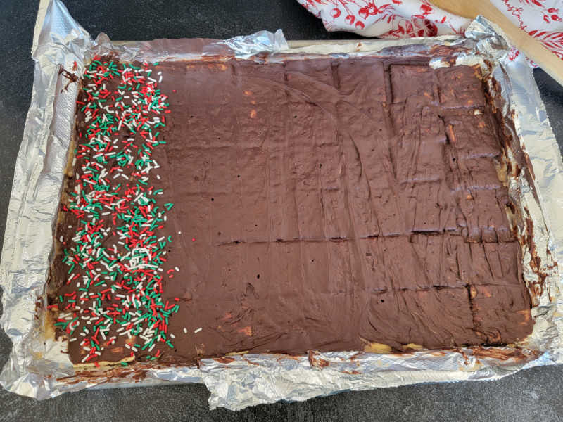 Christmas Crack Saltine Toffee Candy on an aluminum foil lined baking sheet