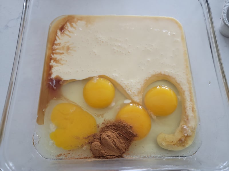 Eggnog French Toast ingredients in a glass pan