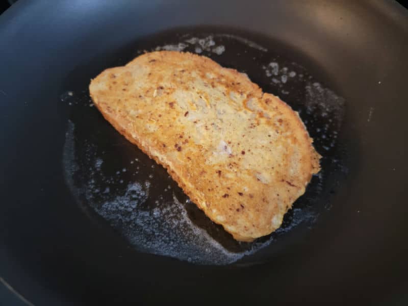 Eggnog French Toast cooking in a pan