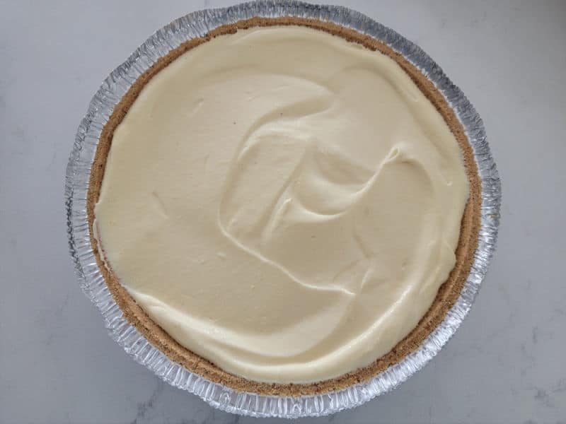 No bake eggnog pie in a graham cracker shell on a white counter