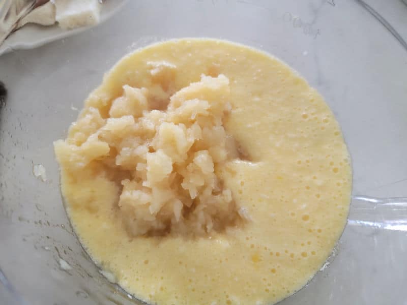 crushed pineapple in butter mixture in a glass bowl for pineapple stuffing