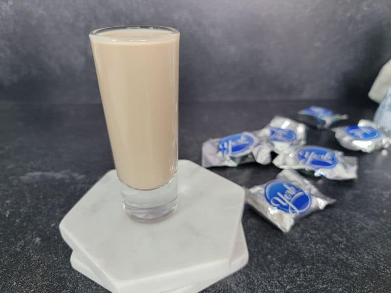 Peppermint Patty Shot on white coasters next to peppermint chocolate candy