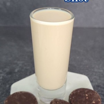 Peppermint Patty Shot text over a filled shot glass with peppermint patty chocolates around it