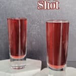 Red Snapper Shot text over two filled shot glasses on white marble coasters