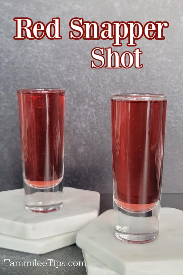 Red Snapper Shot text over two filled shot glasses on white marble coasters