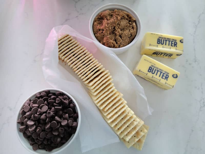 4 ingredients for Christmas Crack, milk chocolate chips, saltines, butter, and brown sugar