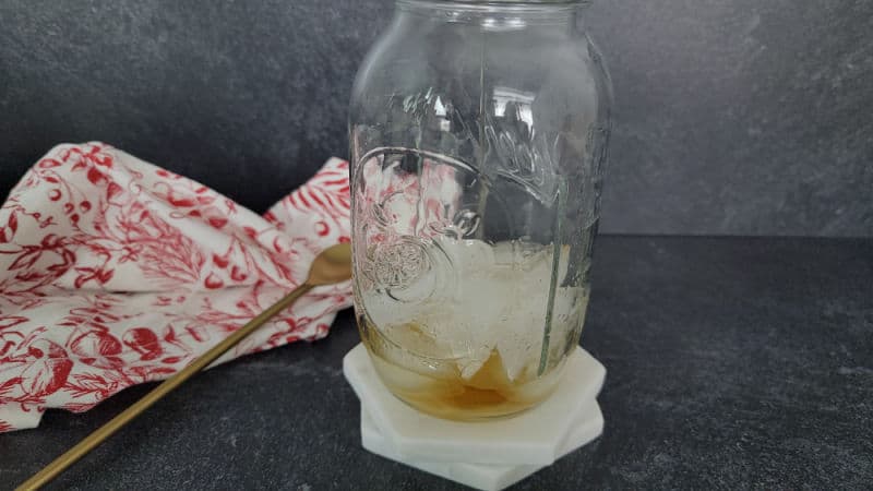 Whisky pouring into a mason jar cocktail shaker for a three wise men shot