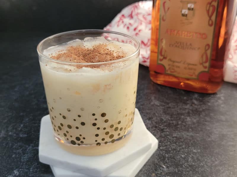 Amaretto Eggnog cocktail garnished with ground nutmeg in glass