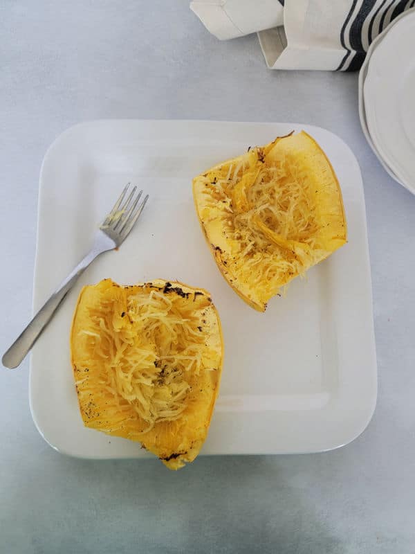 Air fryer spaghetti squash on a white plate with a fork