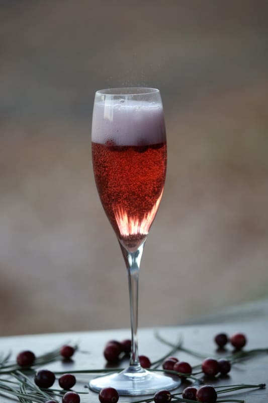 Sparkling cranberry mimosa in a champagne flute 