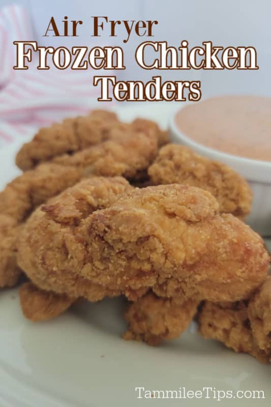 Air Fryer frozen chicken tenders text over chicken on a white plate next to a bowl of sauce