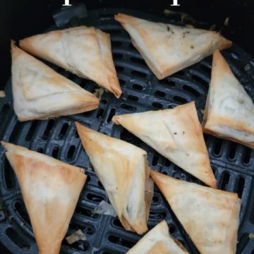 Air Fryer Spanakopita text over triangles of spanakopita in the air fryer