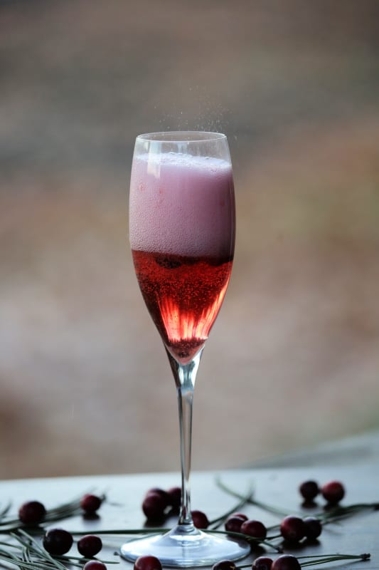 Fizzing cranberry mimosa in a champagne flute