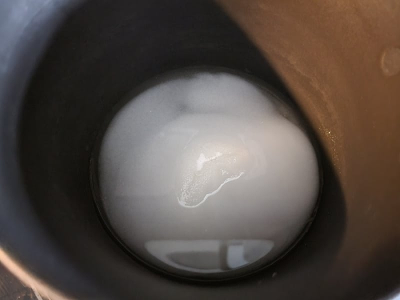 Sugar and water in a saucepan for sugared cranberries