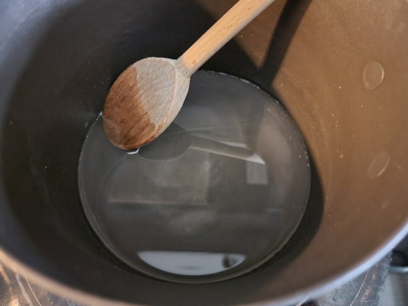 Simple syrup in a sauce pan for candied cranberries