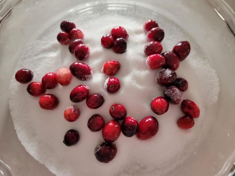 cranberries in a bowl of sugar for candied cranberries