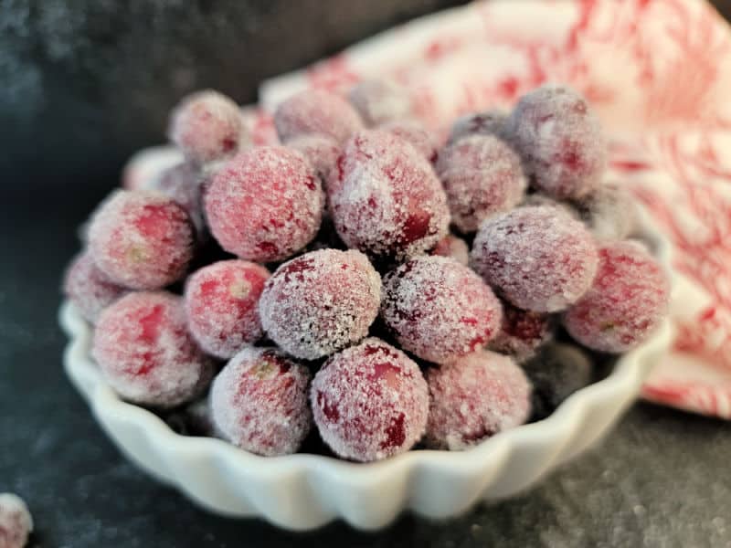 sugared cranberries in a white bowl