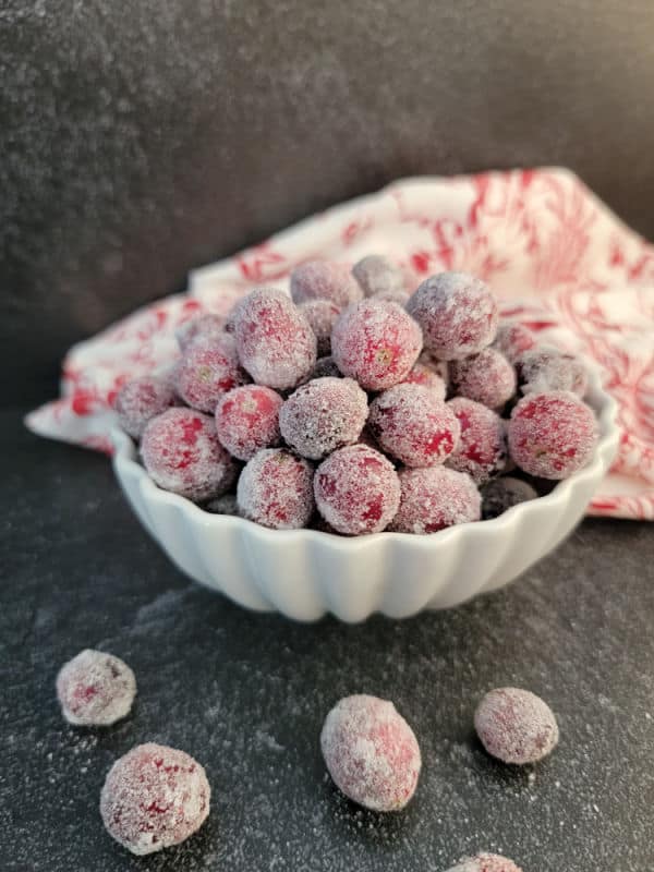 sugar coated cranberries in a white bowl