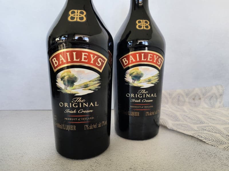 Two bottles of Baileys Original Irish Cream by a cloth napkin